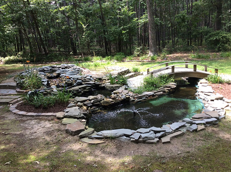 Photos of my five teared back yard streaming pond with bridge